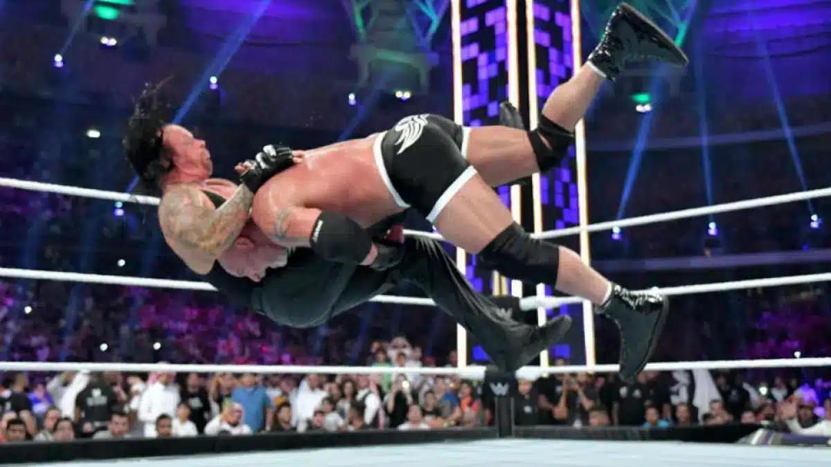 Goldberg performing Spear and Jackhammer on The Undertaker