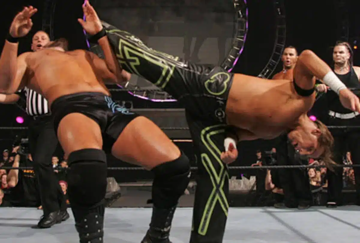 Shawn Michaels performing Sweet Chin Music on an opponent one of 