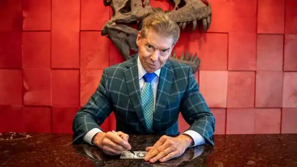 Vince McMahon sitting at his WWE office desk