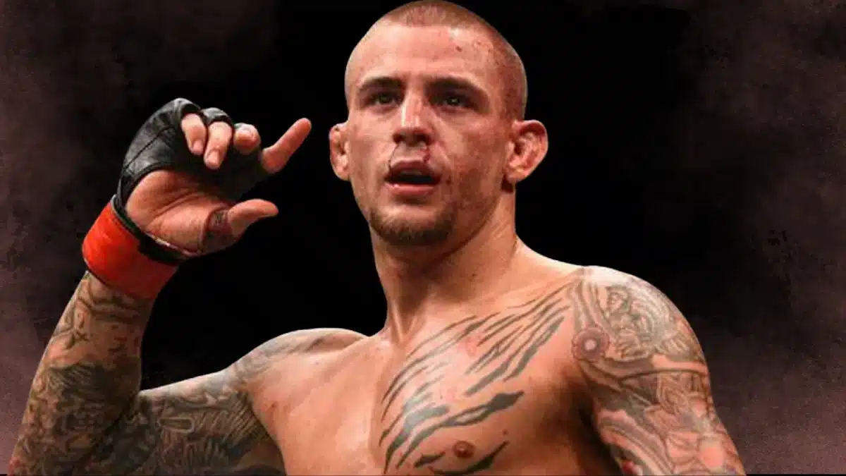 Dustin Poirier pointing to his ear signalling that he is listening