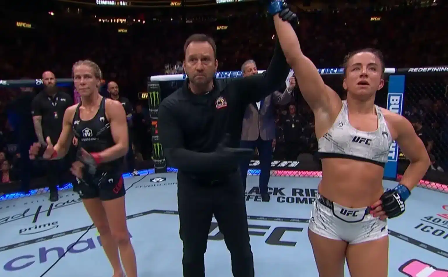 The referee lifts Maycee Barber's arm in the centre of the octagon after her victory over Katlyn Cerminara at UFC 299.