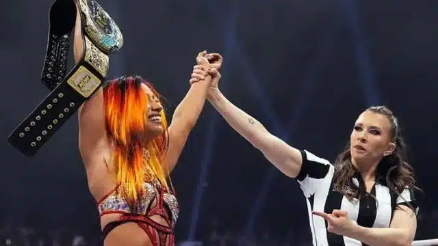 Mercedes Moné Is Holding Her Tnt Belt After Receiving It From The Referee Who Is Pointing At Her In The Ring At Aew Double Or Nothing 2024