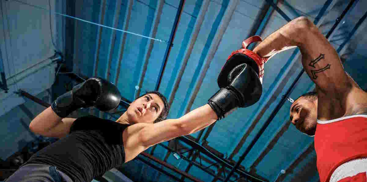 Boxing Combinations: The Female Boxer And Afro American Male Boxer Training Box At Gym