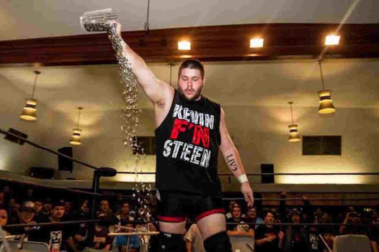 Kevin Owens celebrating with water jug